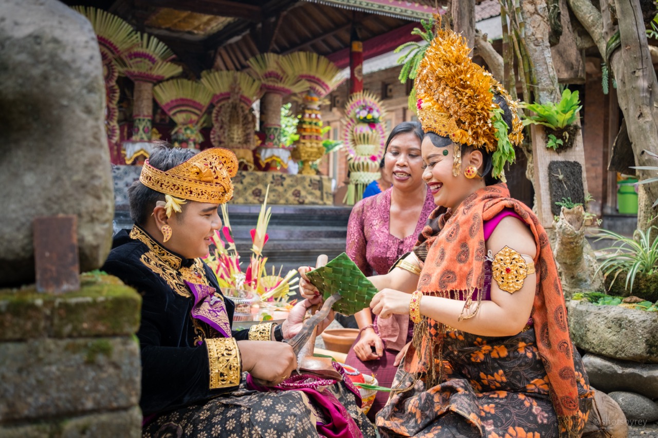 Balinese temple ceremony atmosphere with soft lighting and traditional umbrellas