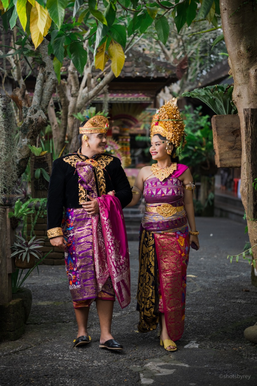 Close up of traditional Balinese wedding couple hands with gold jewelry